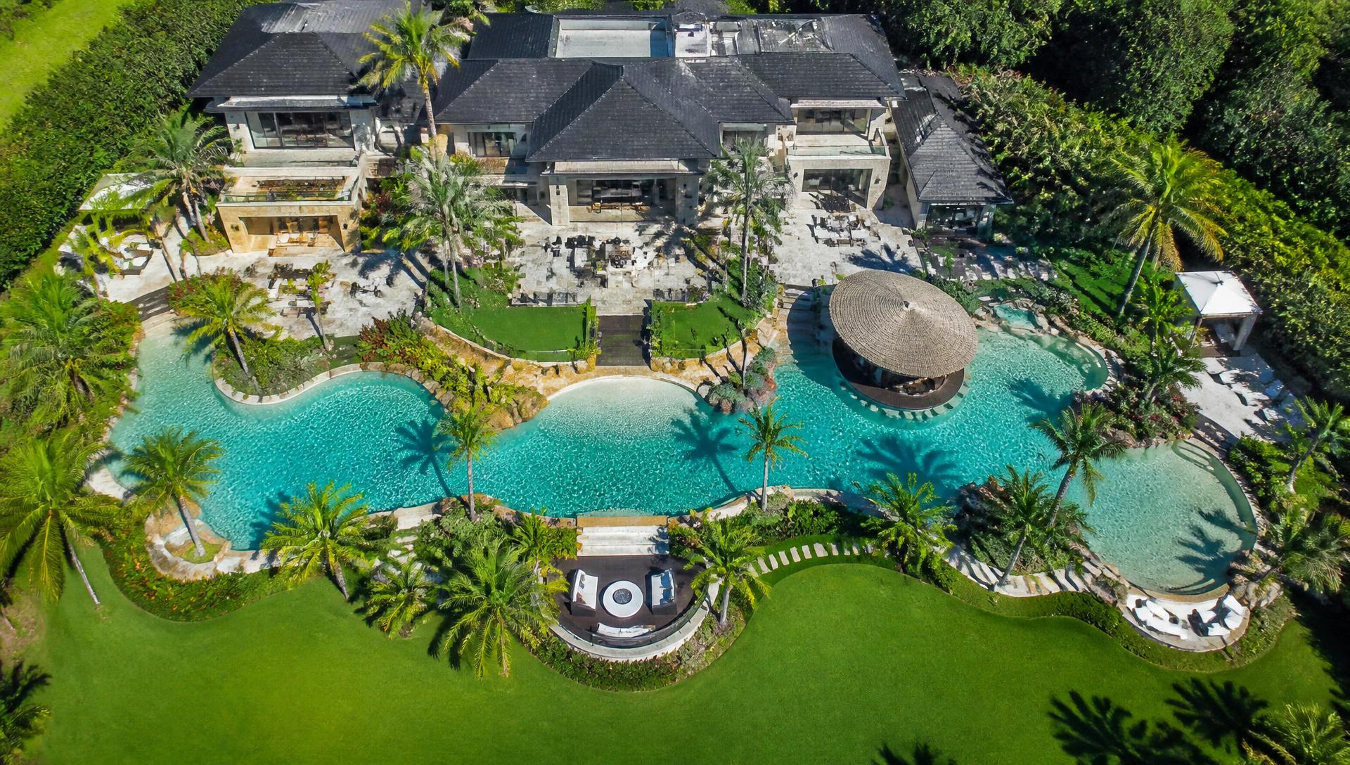 Aerial top view of luxury exotic estate with turquoise freeform pool cabanas and tropical palm gardens. Images Created by www.future-home.shop